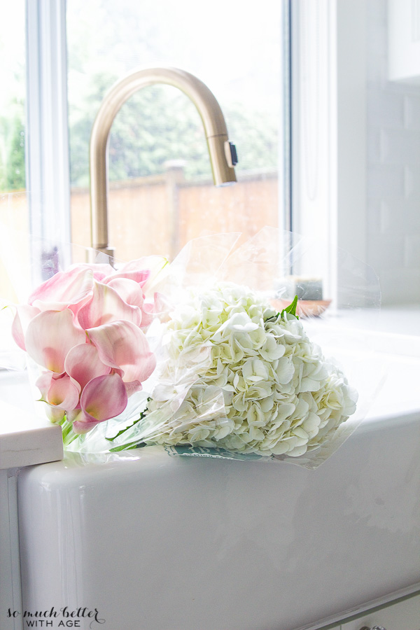 Pink and white flowers in the sink.