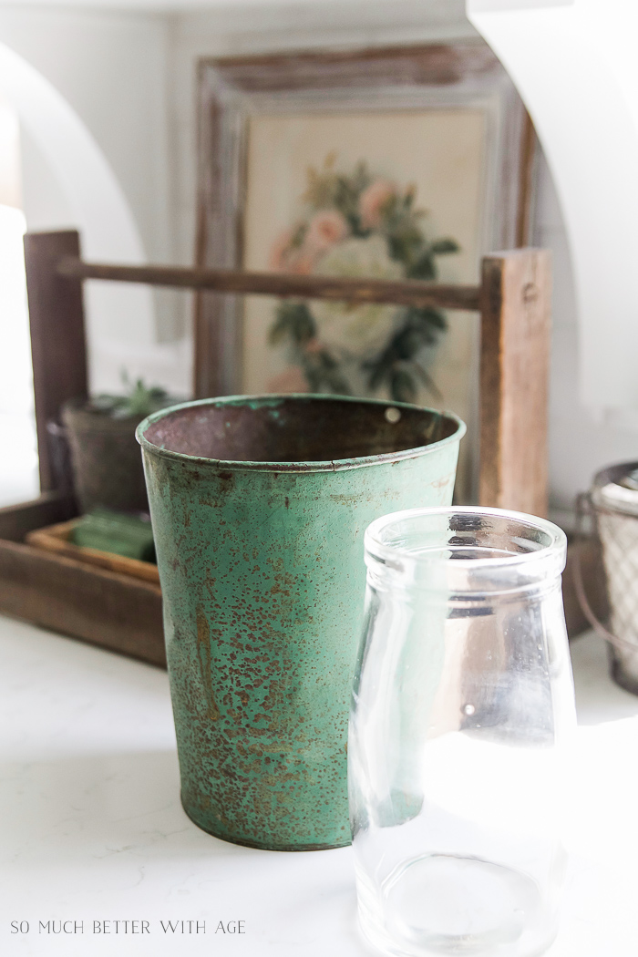 Green sap bucket on counter in kitchen.