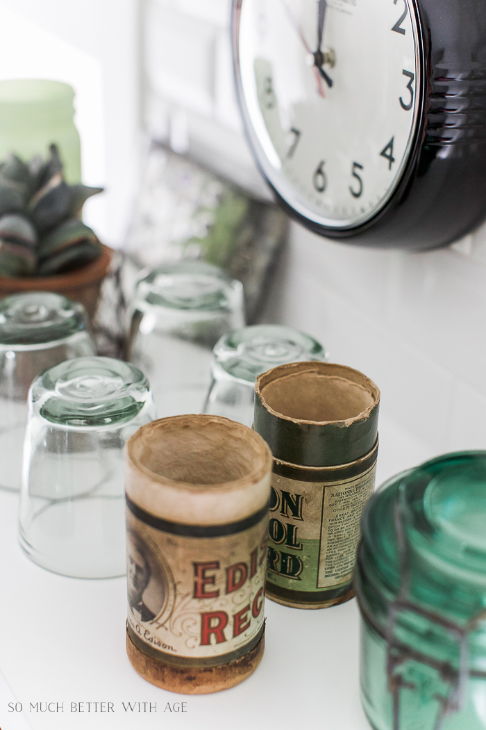 Cups and vintage containers on counter in kitchen.