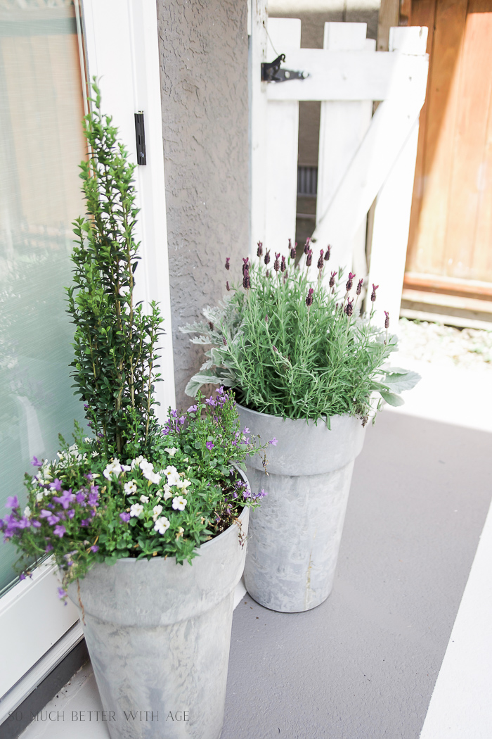 Outdoor planters filled with florals and greenery.