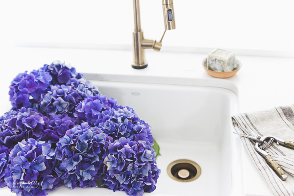 Beautiful flowers & kitchen details, Delta Trinsic faucet, Kohler apron-front sink / flowers and French linen.