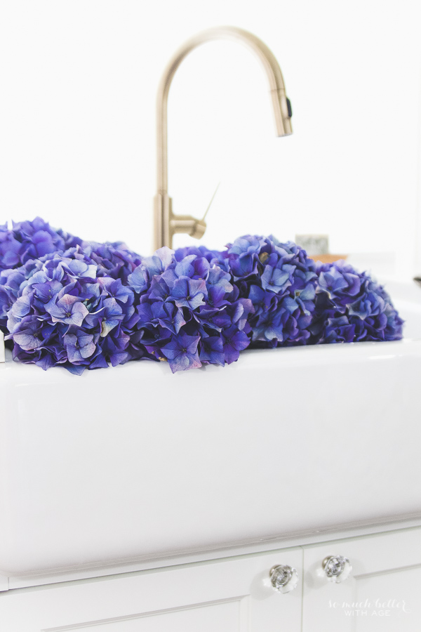 The blooms in the white apron sink.