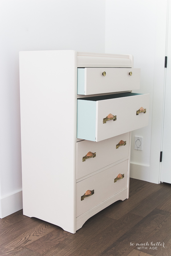 The dresser in the room with one drawer open.