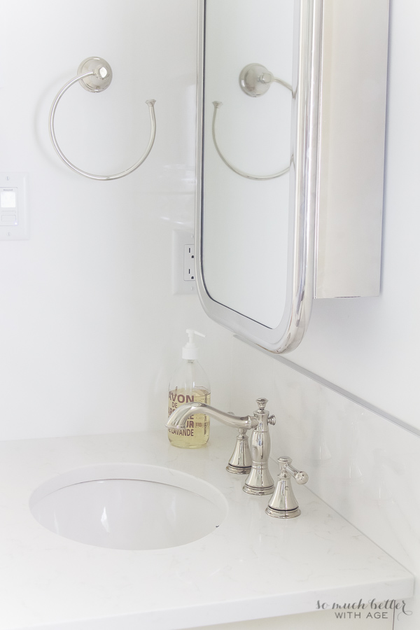 A towel ring beside the mirror in the bathroom.