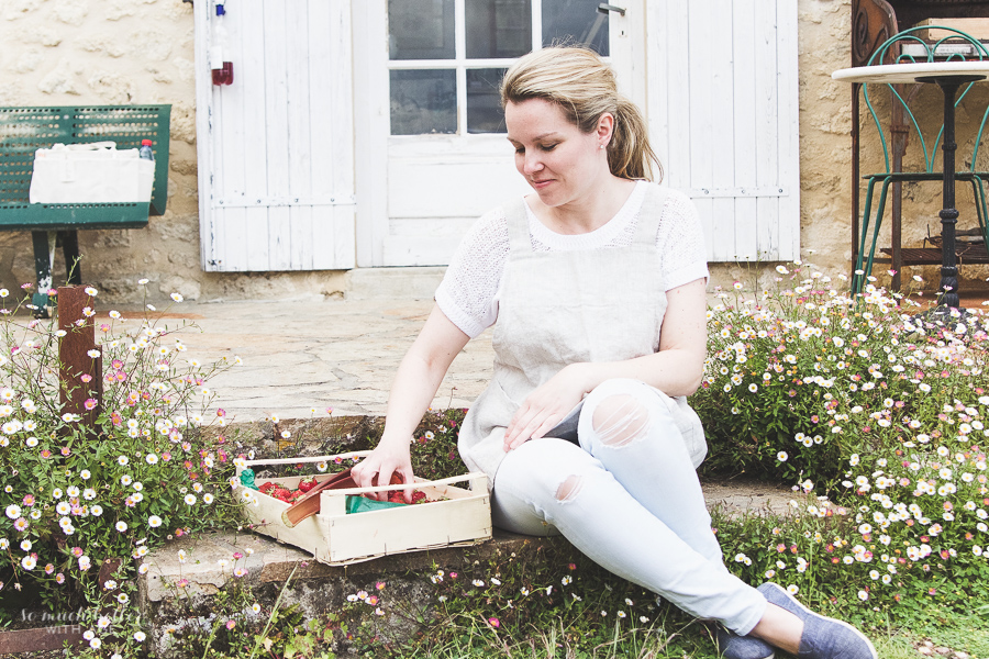Jamie posing with a wooden crate of rhubarb.