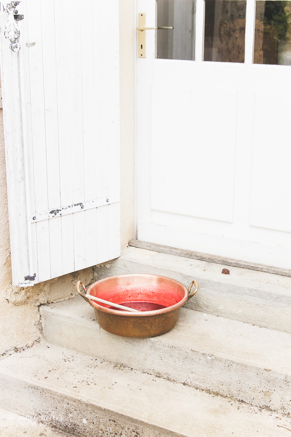 The copper pot filled with the jam on the stairs for photographing.