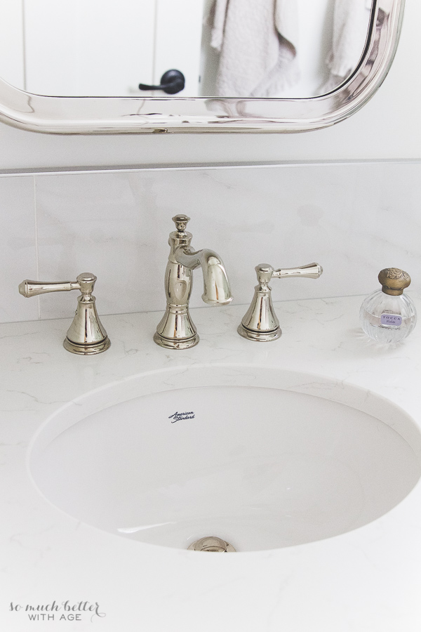 Polished nickel faucet from Delta, polished nickel medicine cabinet from Restoration Hardware.