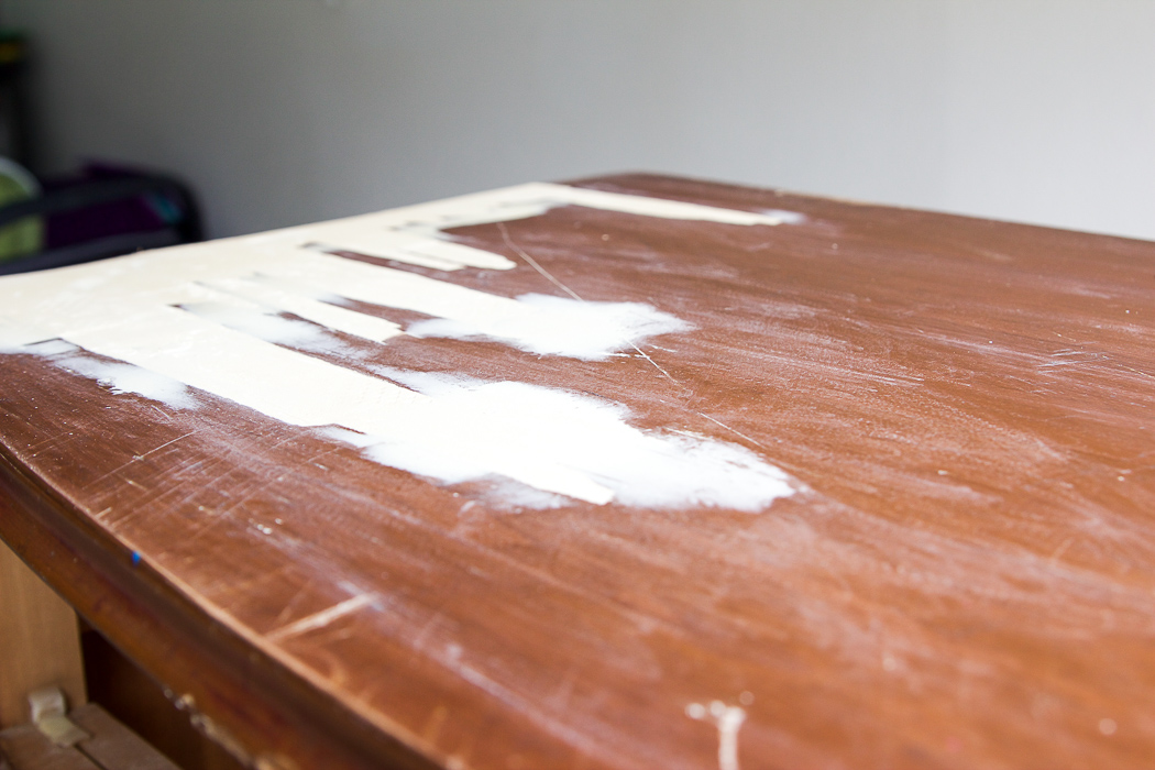 Large amount of wood putty sanded off dresser top. 