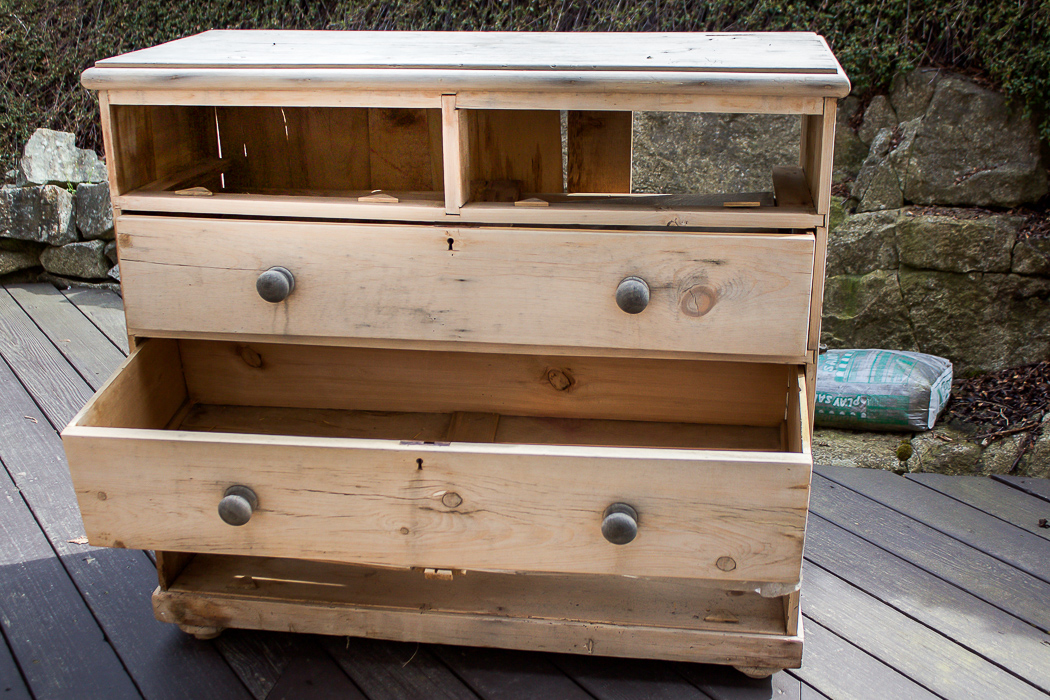 Damaged dresser with missing drawers. 