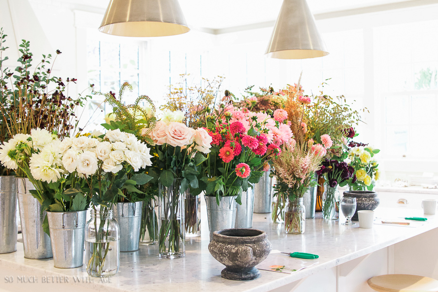 The kitchen island filled with flowers all different kinds.