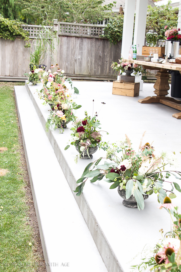 Everyones floral arrangements outside on the patio lined up.