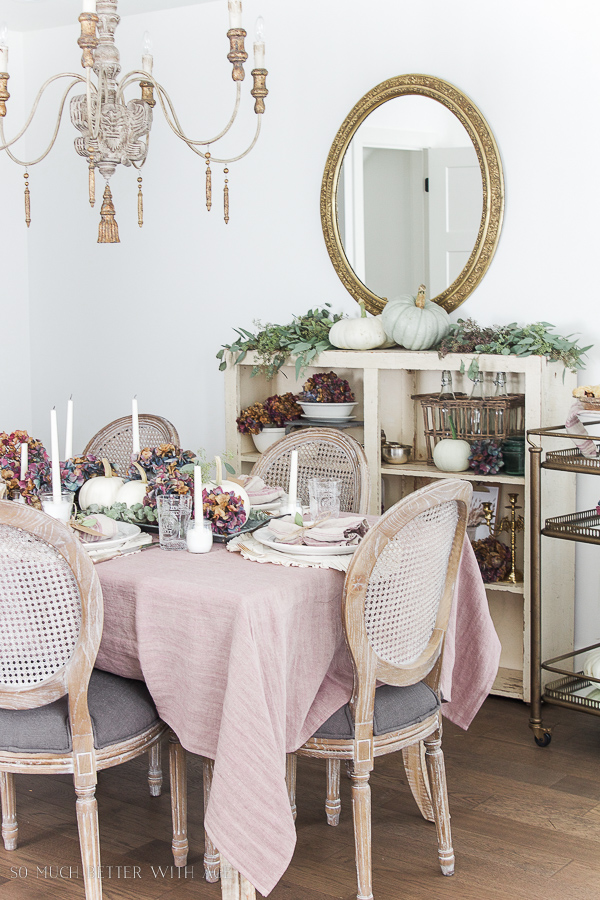 There is a French chandelier hanging above the dining room table.