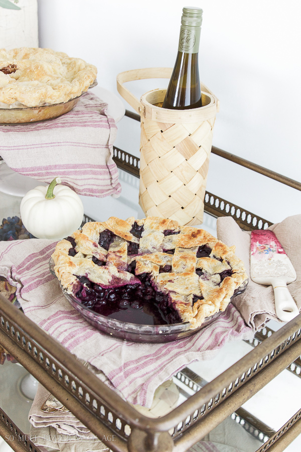  Pies and wine on a gold bar cart.