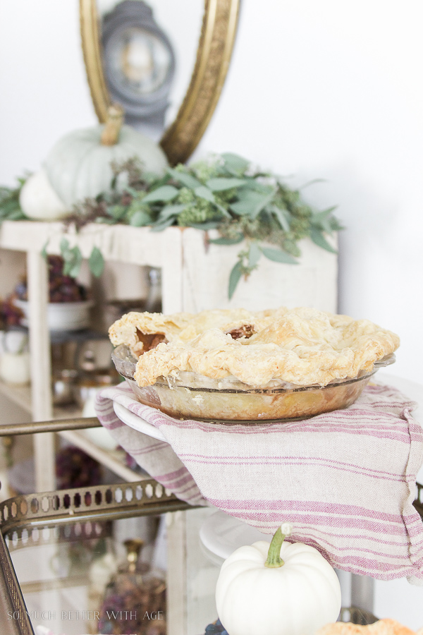 A baked pie is on the pie stand.