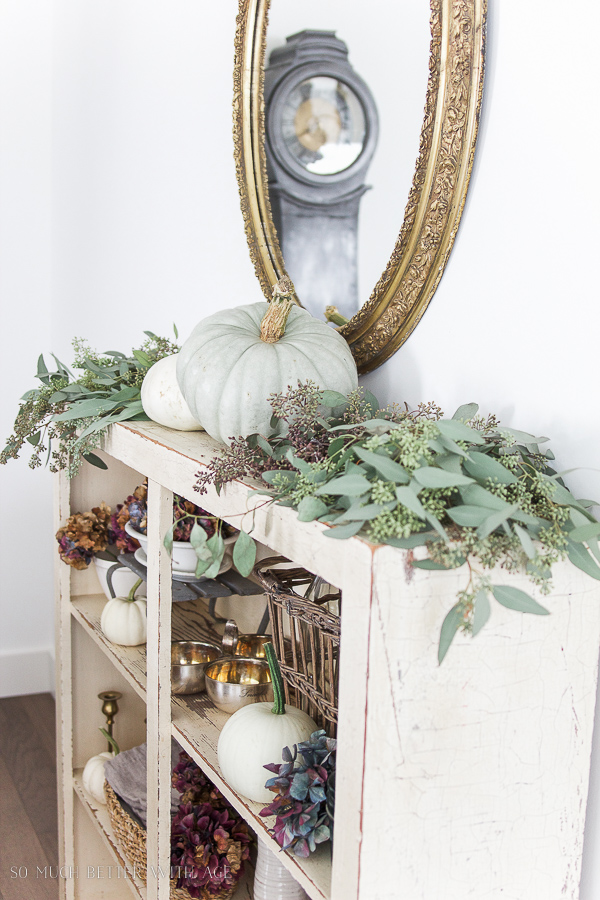  Heirloom pumpkins with seeded eucalyptus and gold mirror, Mora clock.