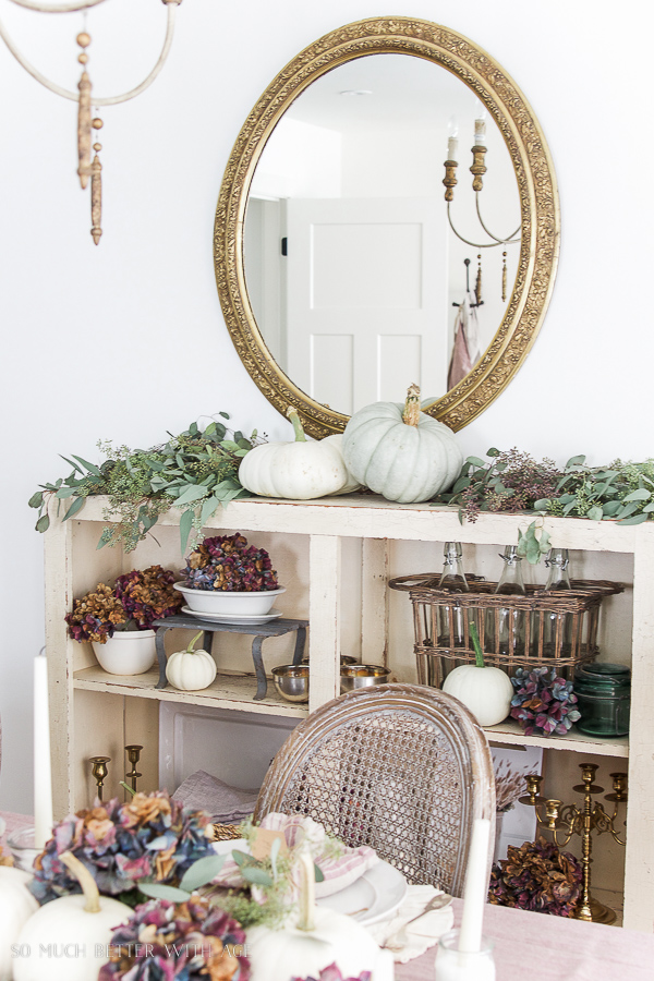 French gold mirror from Soft Surroundings with heirloom pumpkins, hydrangea and seeded eucalyptus.