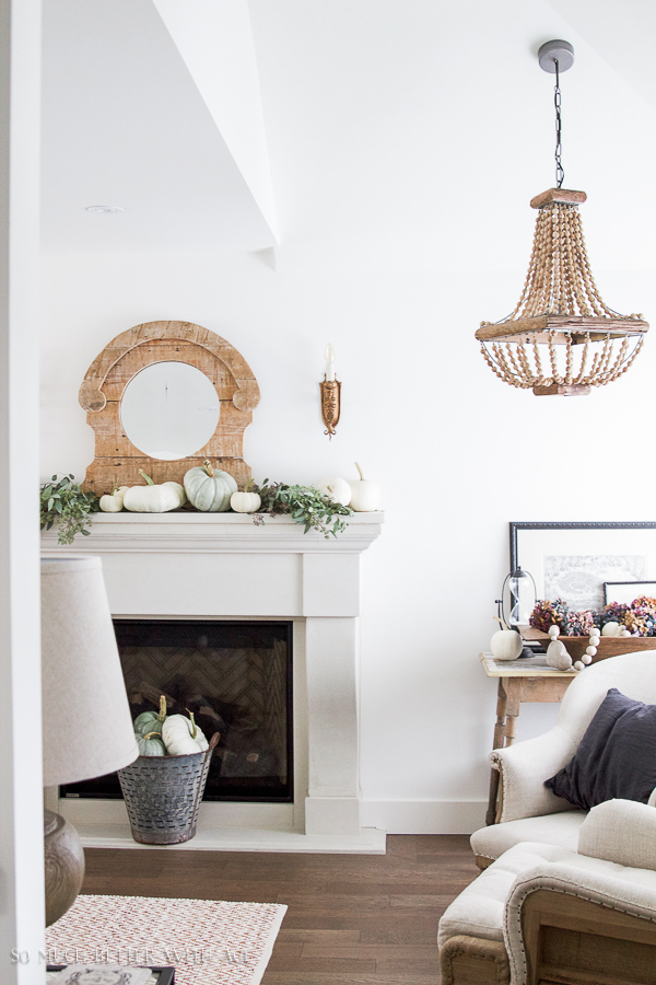 The installed fireplace with neutral armchairs and a neutral rug in front of it.