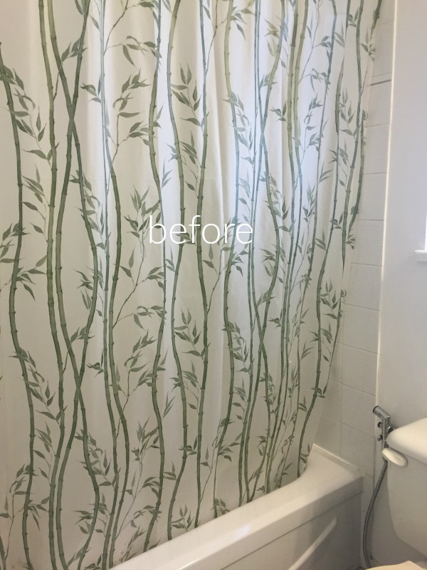 A 1980's tub with a bamboo shower curtain.