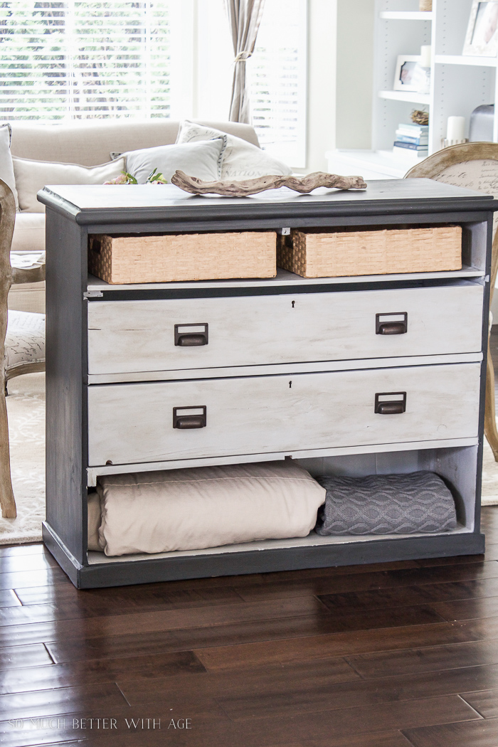 Grey painted dresser with open drawers. 