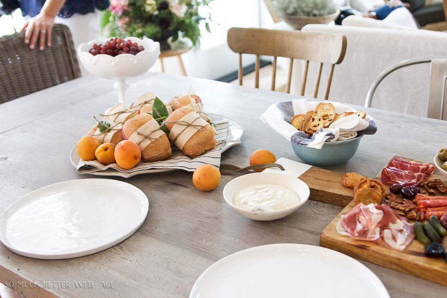 There is bread bows and apricots on the table.