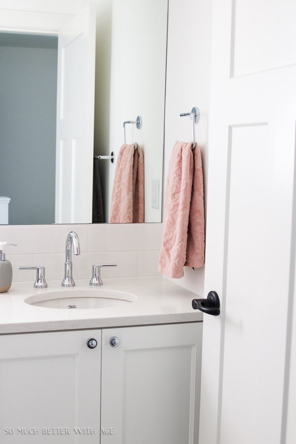 Simple pink towels are in the bathroom.