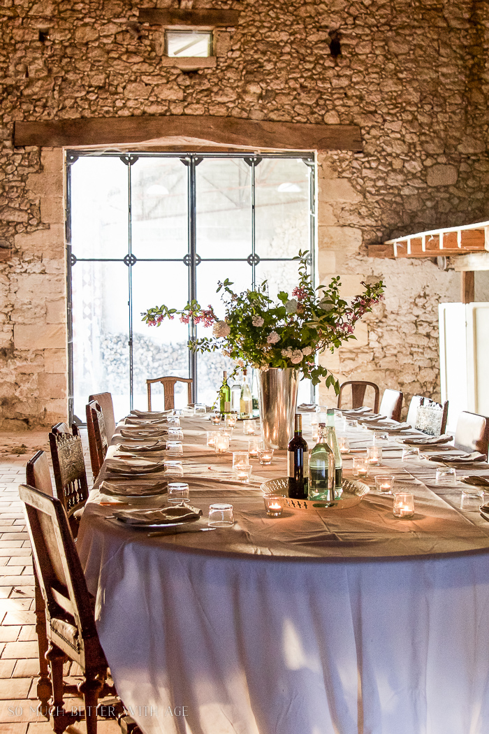 An old French barn with a table set for dinner.