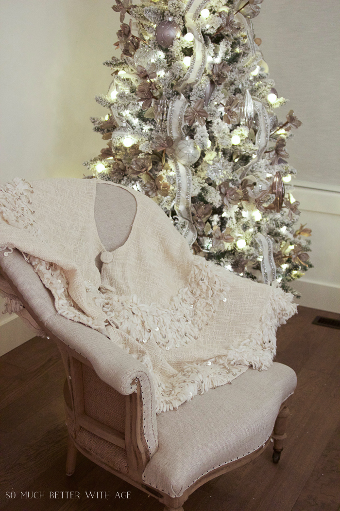 Linen tree skirt on the armchair beside the tree.