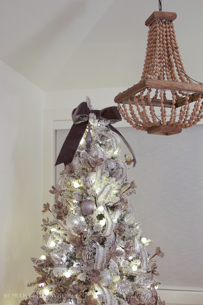 The bronze bow on top of the tree.