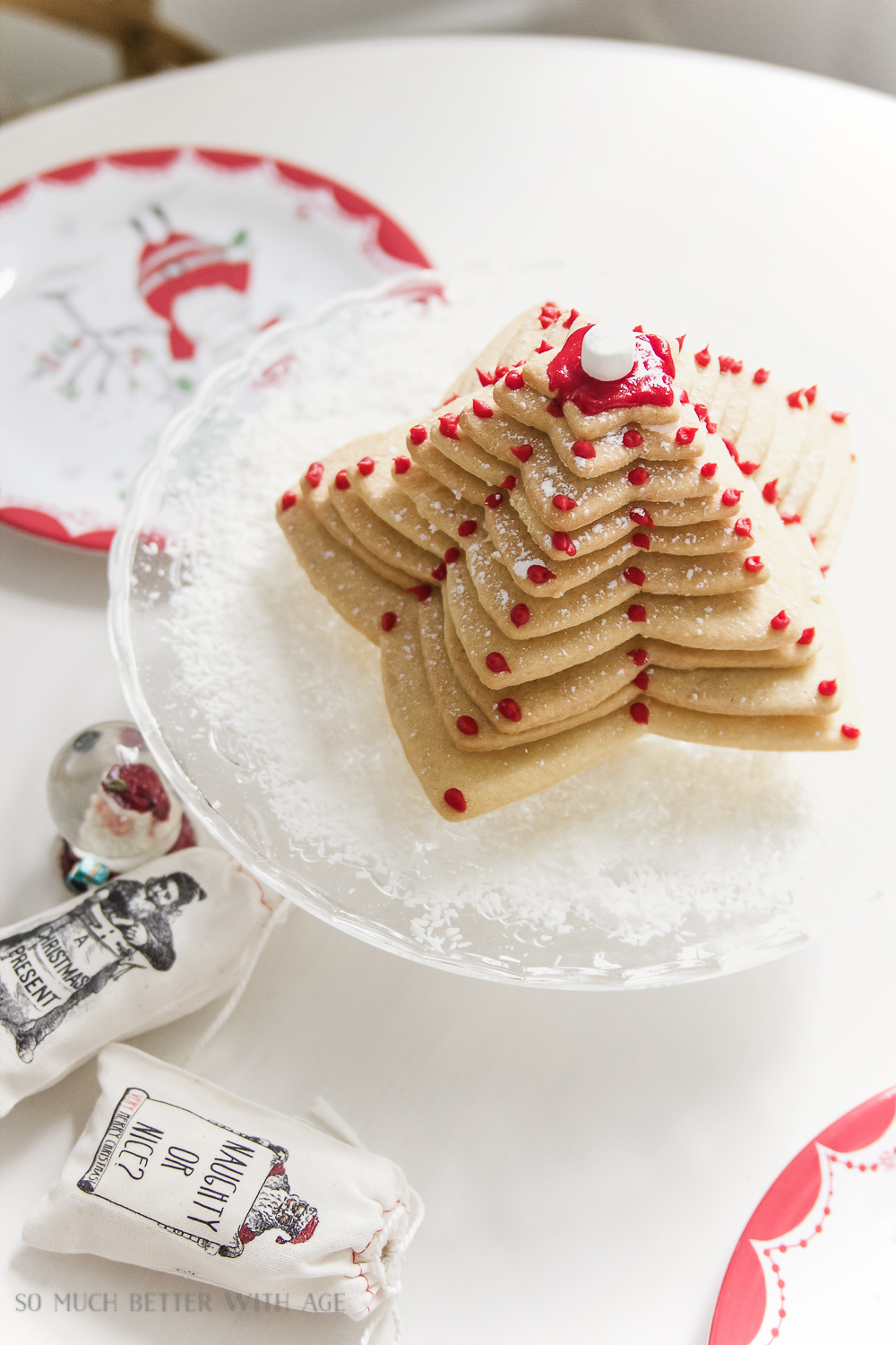 The sugar cookie tree on a plate with red dots of icing.