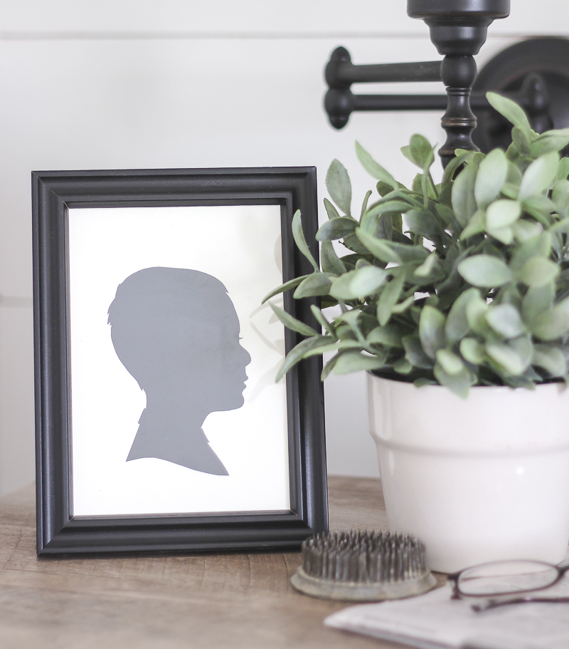 A silhouette picture inside a black frame.