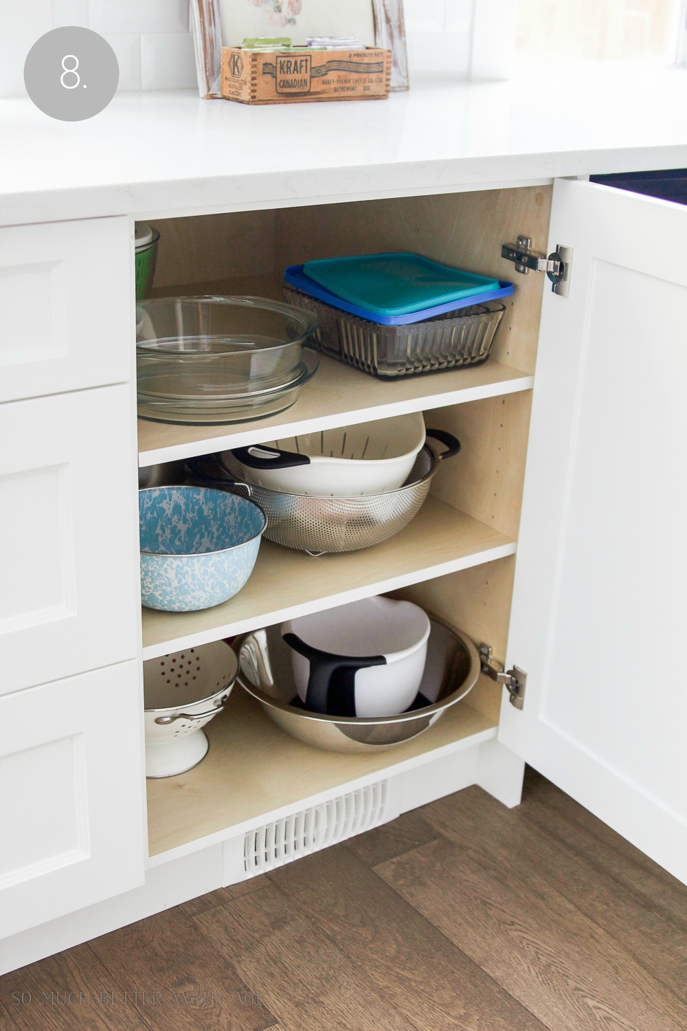 Putting baking bowls into the cupboard.