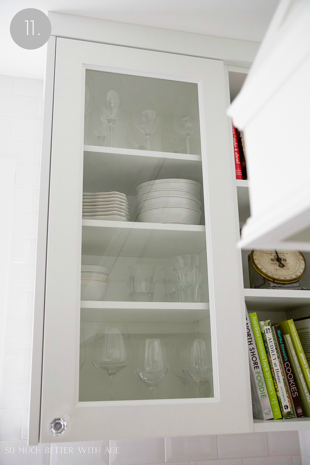 Wine glasses and plates organized in cupboard.