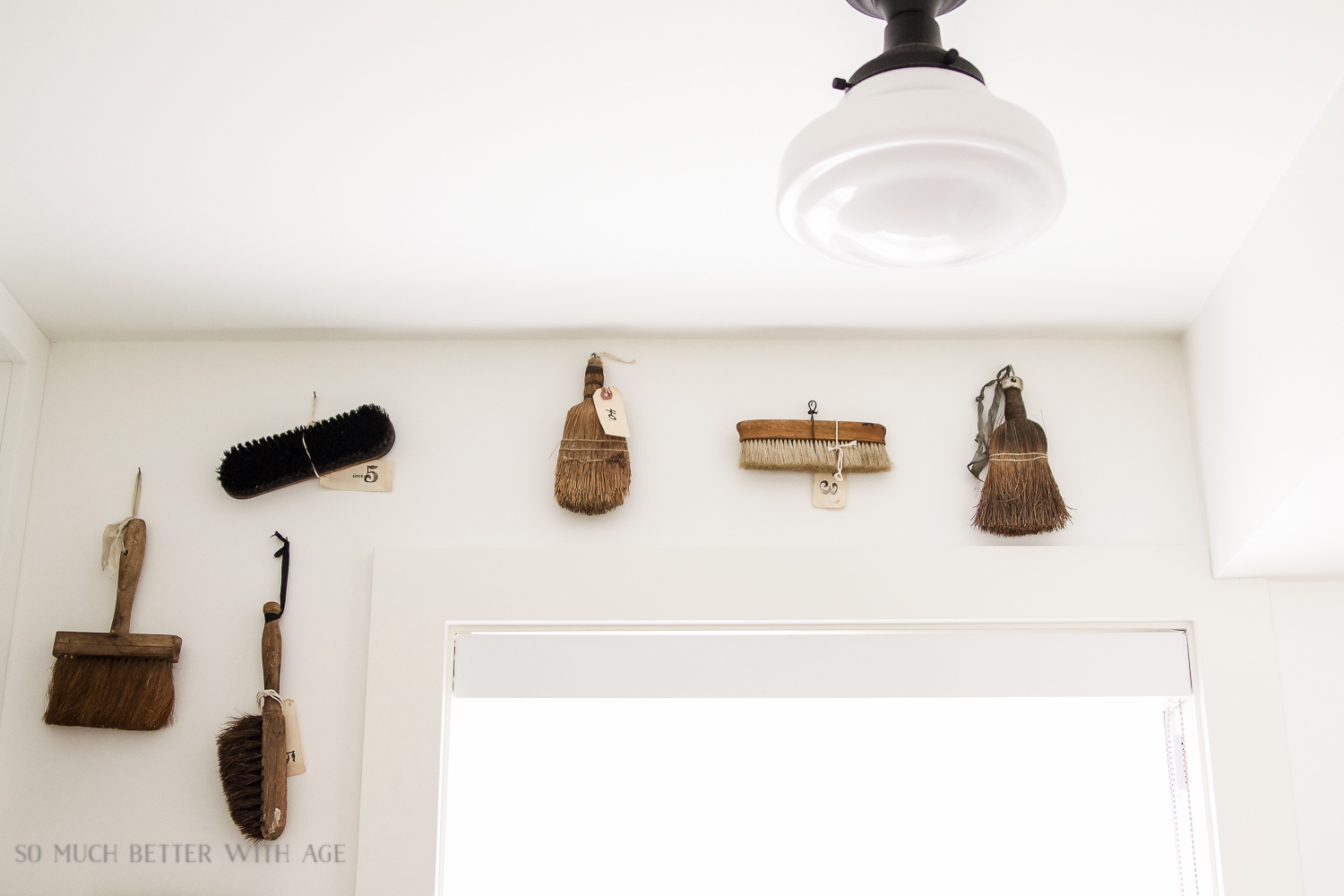 Brush items hanging on the wall in the mudroom.