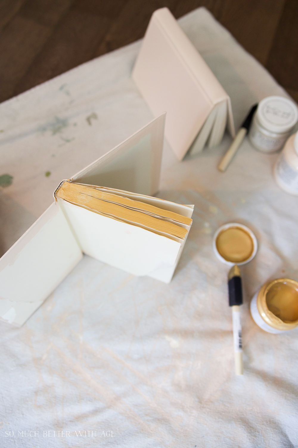 The old books being painted with gold paint.