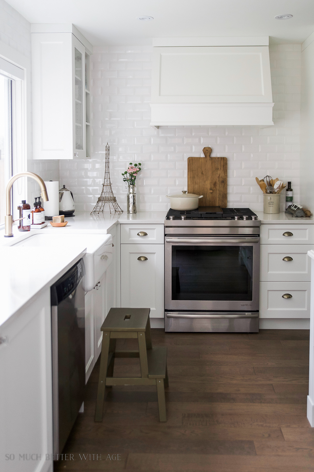 A white kitchen with an Eiffel Tower on the counter.