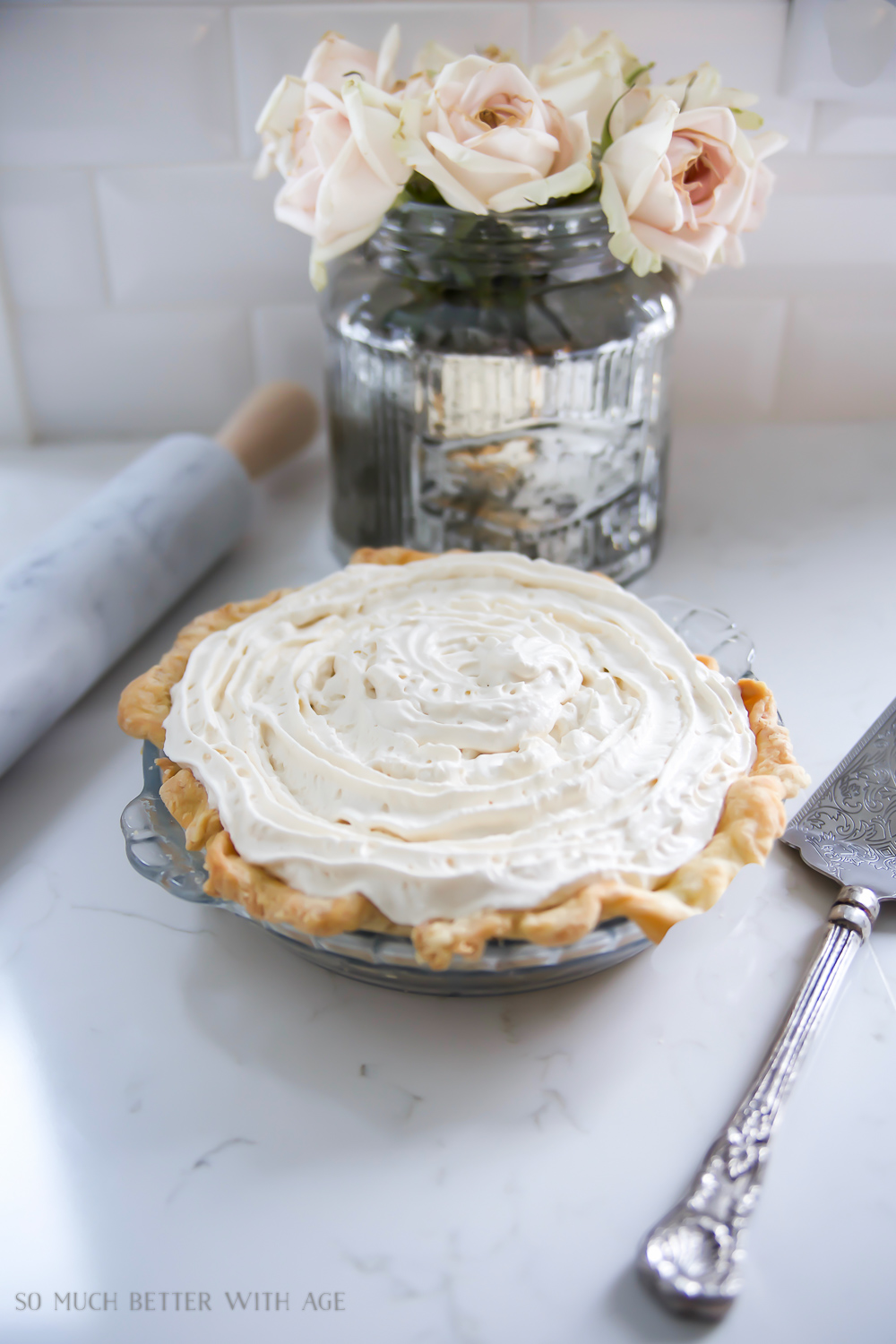 Vanilla cream pie with chocolate ganache bottom sitting on the counter.