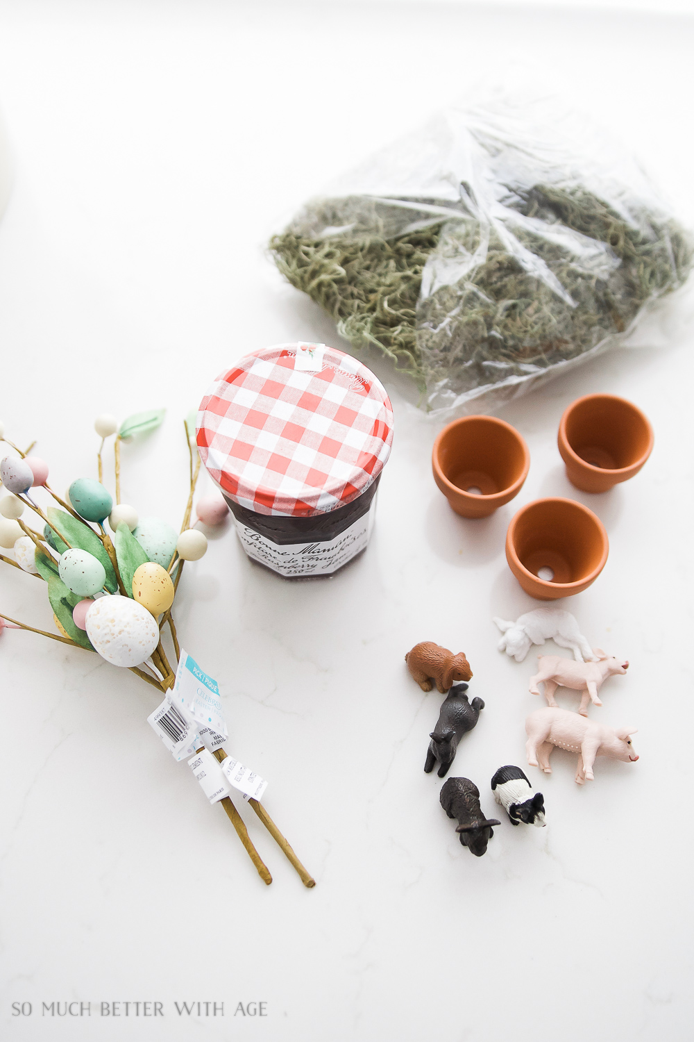 The jars and easter eggs, plastic animals on the table laid out.