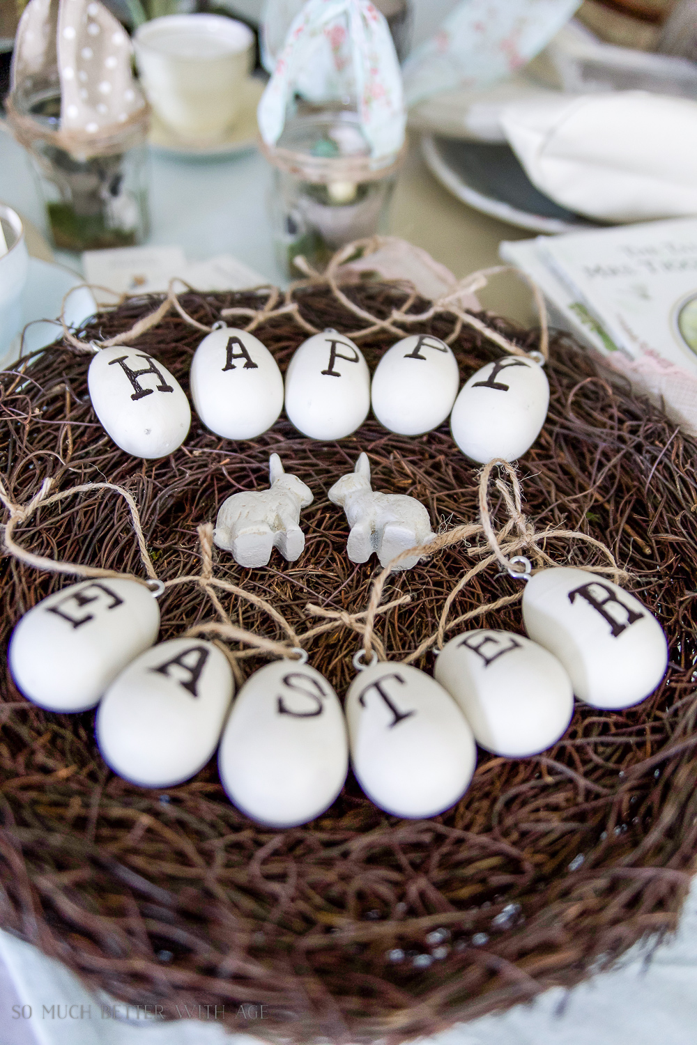 Two bunnies in the nest beside the garland.