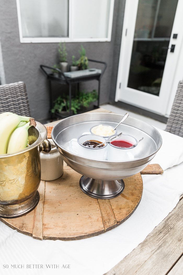 Sauces for banana split in beverage container outside. 