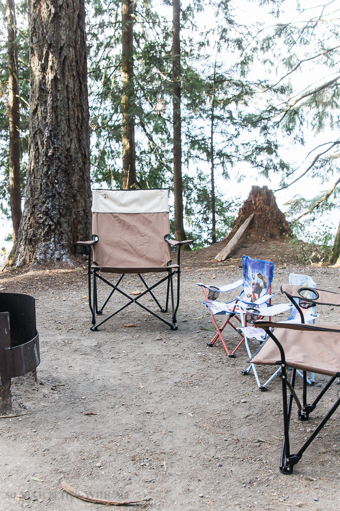 Folding chairs set up by lake.