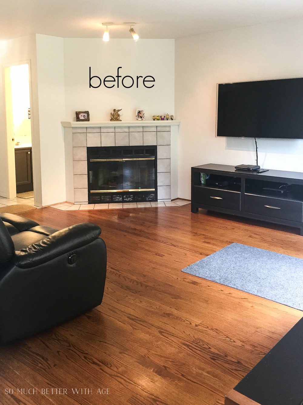 The dining room before with an old fireplace and wood floors.