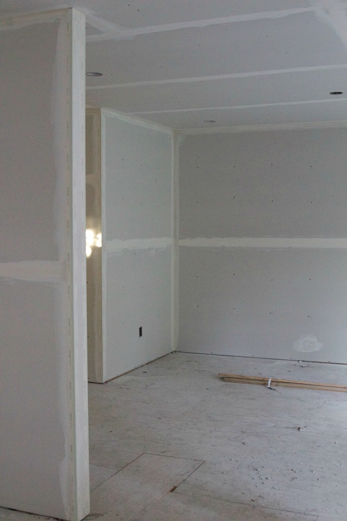 Using drywall mud to fill in all the holes fro the nails in the drywall.