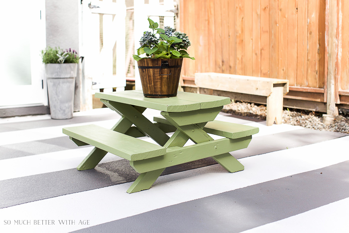 The small table on a striped patio deck.