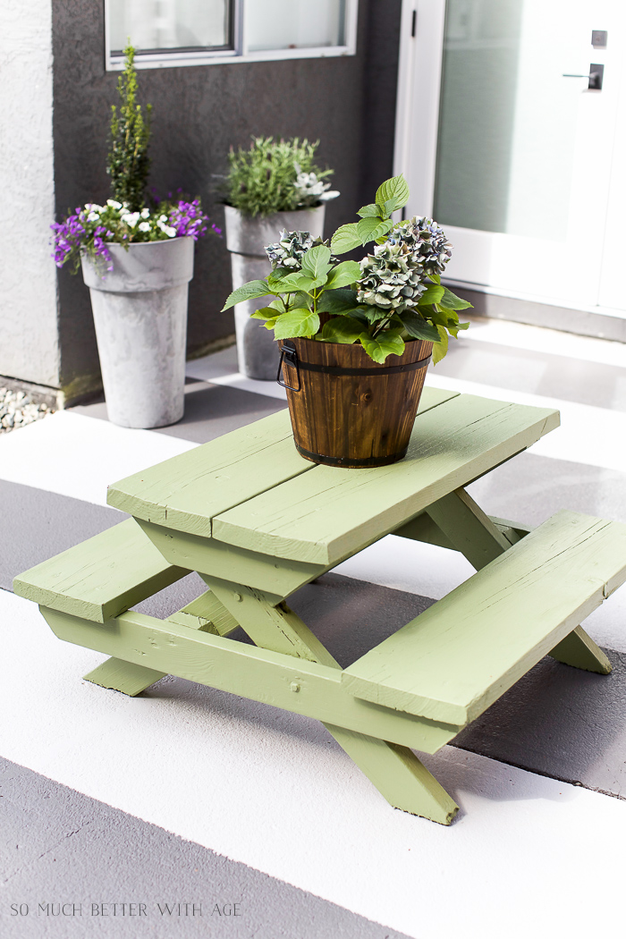 The table painted a light green on the patio.