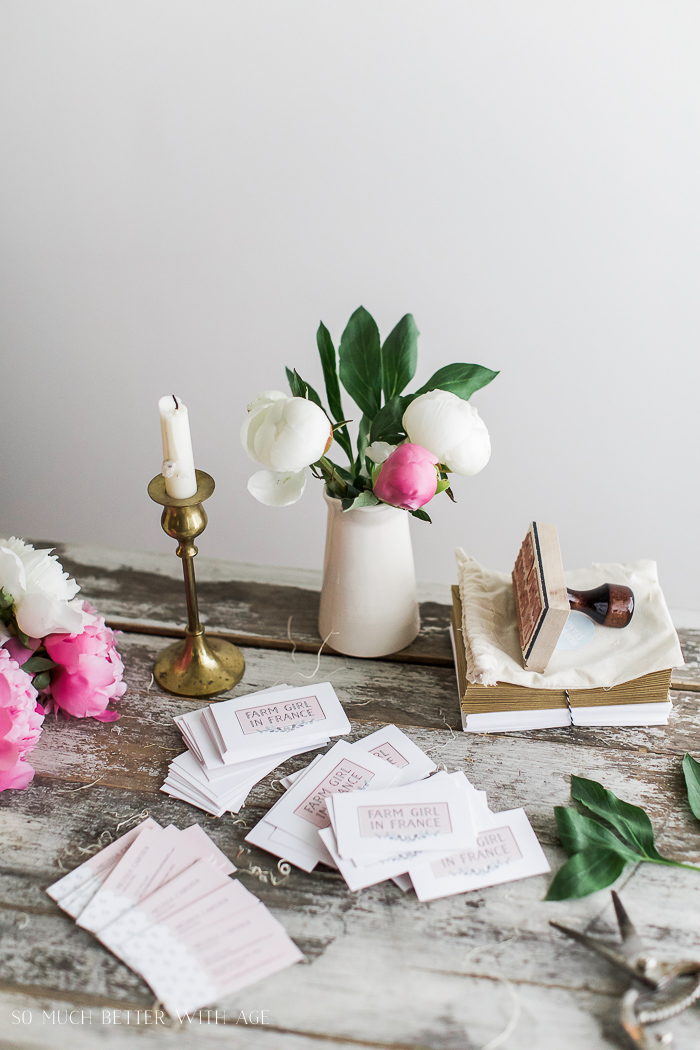 There is a candle on the table beside the stamp.