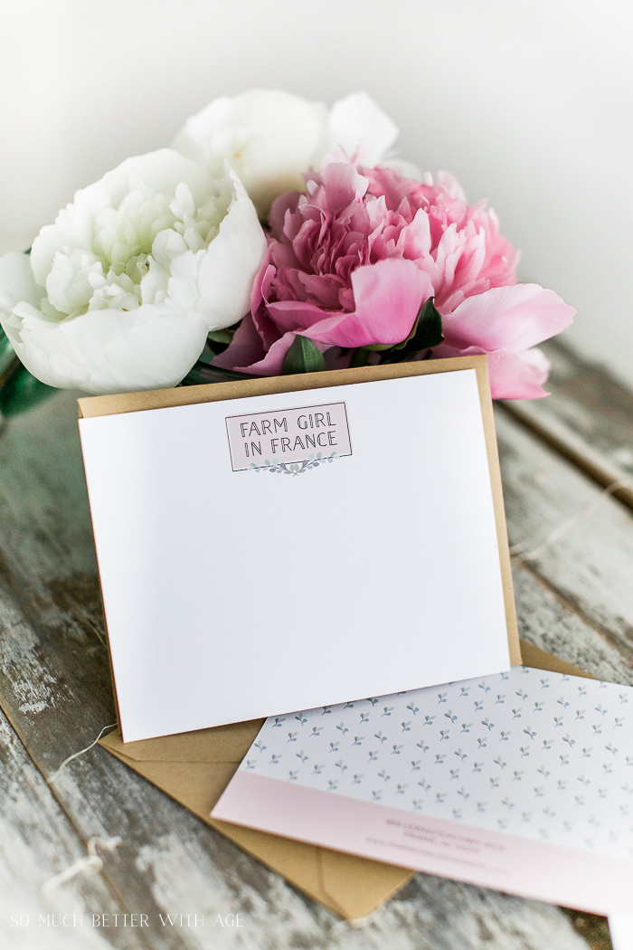 The cards leaning against the peonies.