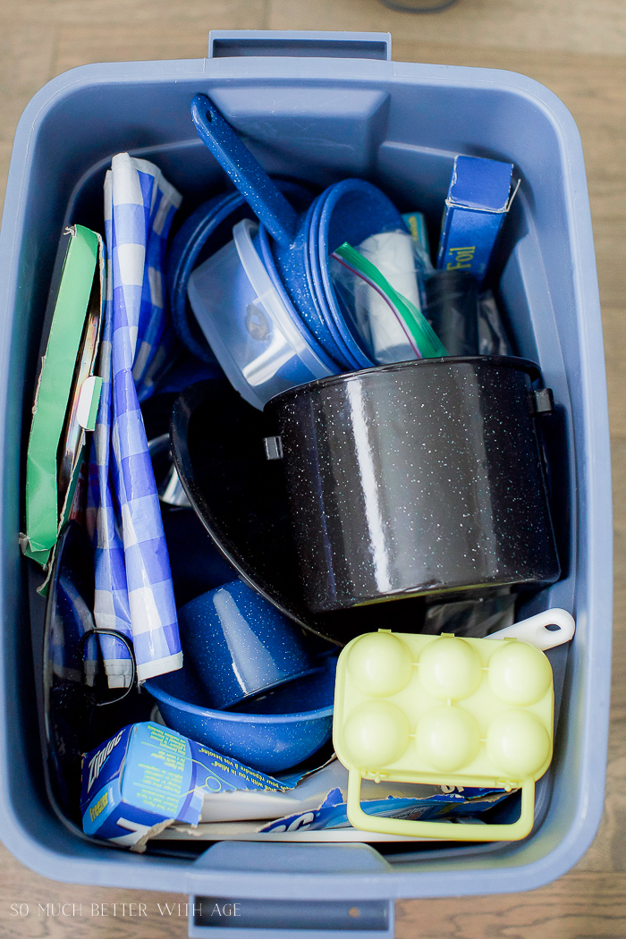 Pots and pans in blue bin.