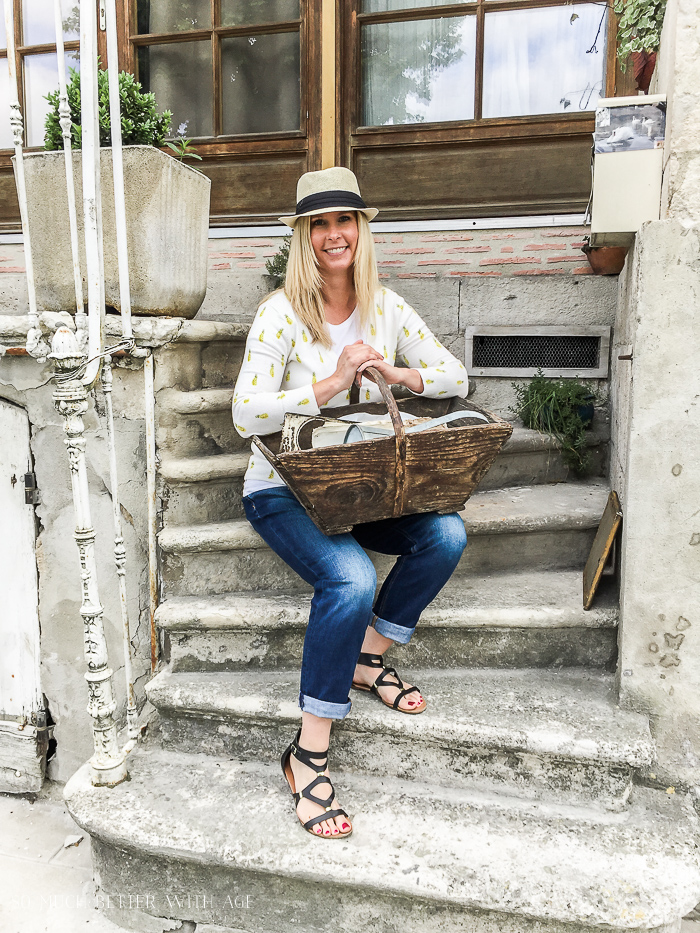 A woman holding a wooden basket.