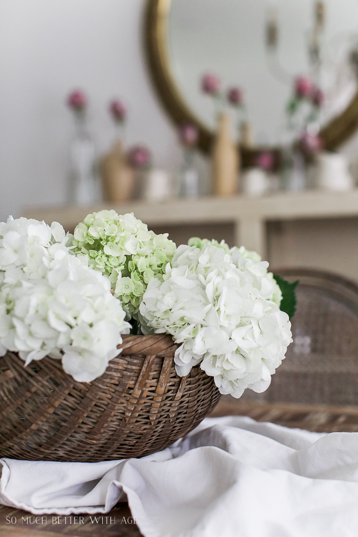 Vintage basket with white hydrangeas in it.