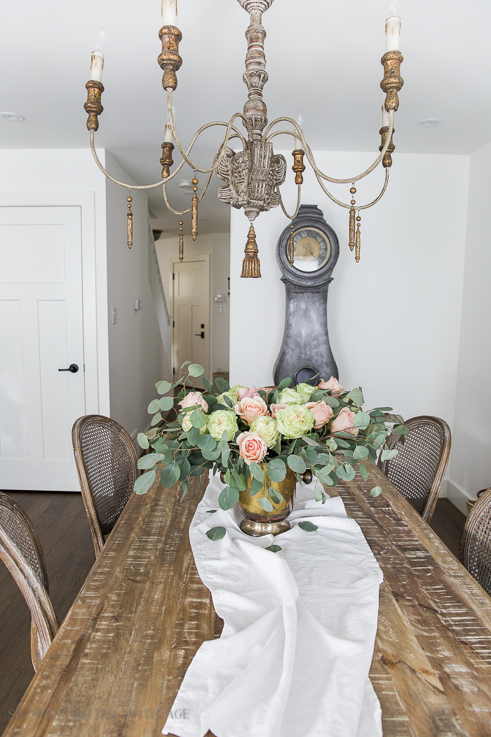 White table runner, with floral centerpiece.